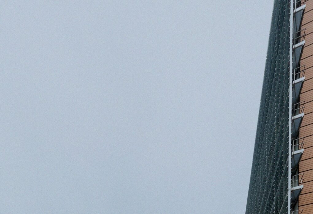 Corner of the Berlaymont building in Brussels against overcast sky, no people or brand logos