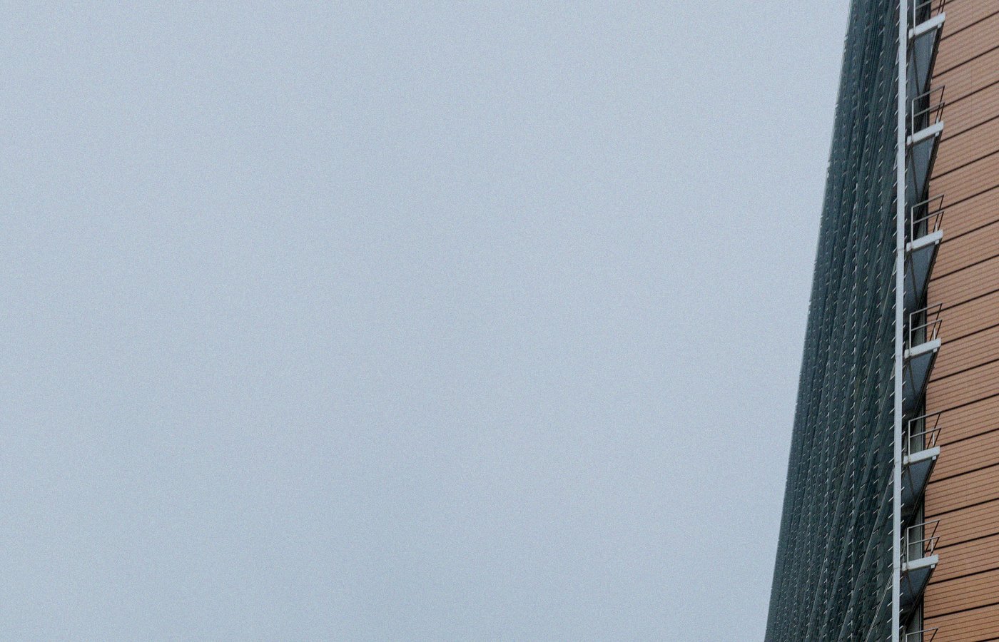 Corner of the Berlaymont building in Brussels against overcast sky, no people or brand logos