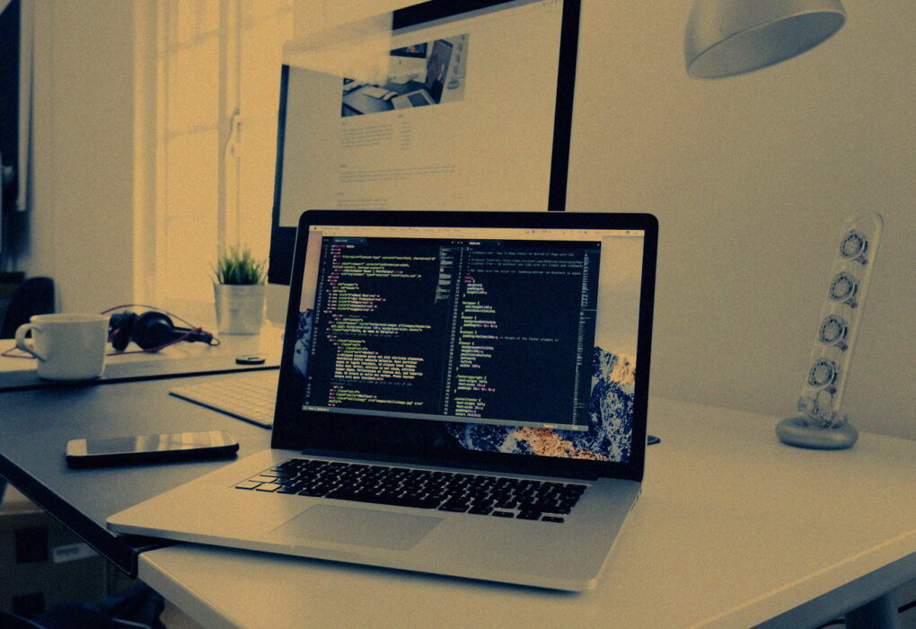 Dim developer desk with a glowing terminal and soft clustered lights, no people or logos