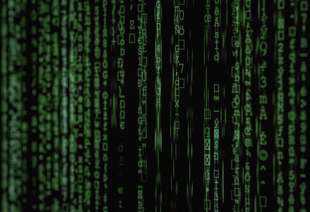 Face-free green digital code cascade on black screen — related still for Aslan $20.8M seed national-security AI undercover agent coverage
