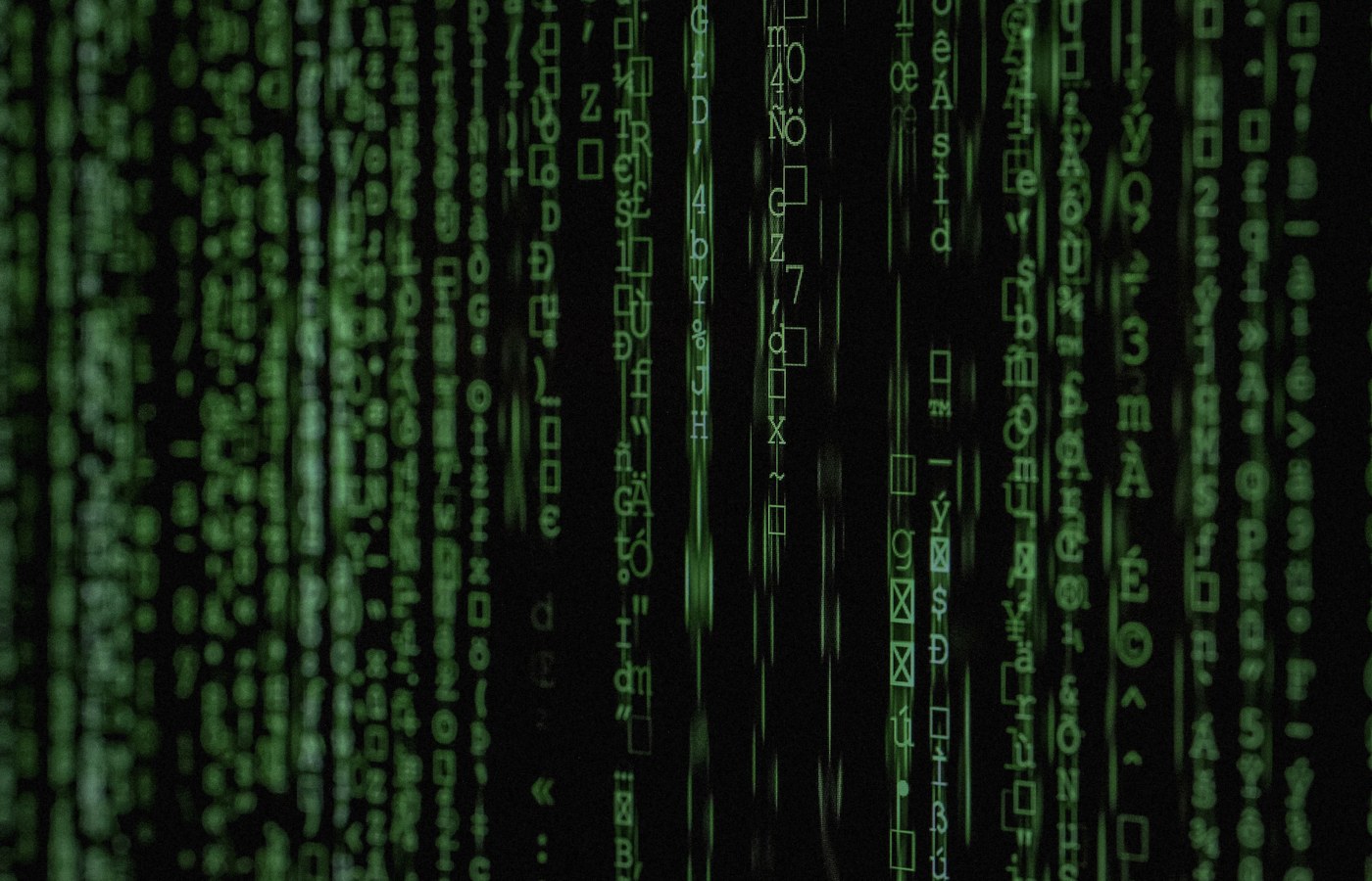Face-free green digital code cascade on black screen — related still for Aslan $20.8M seed national-security AI undercover agent coverage