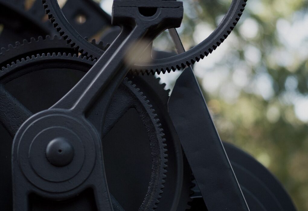Face-free close-up of dark interlocking metal gears
