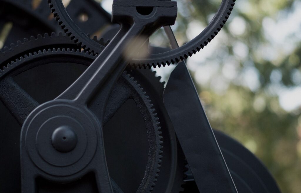 Face-free close-up of dark interlocking metal gears