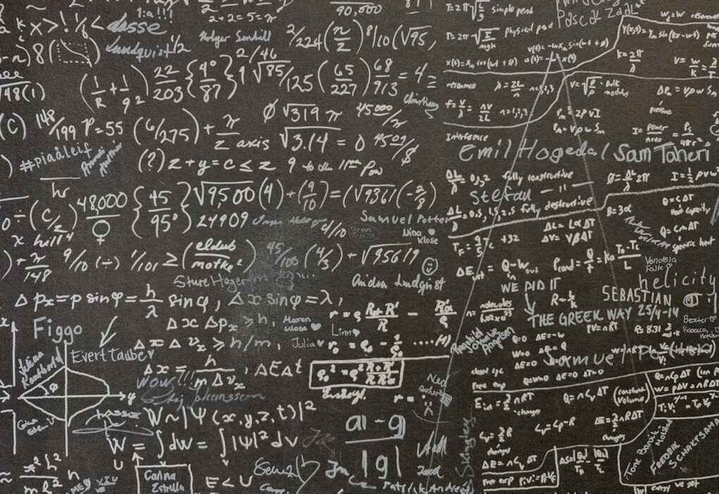 Face-free Unsplash chalkboard densely covered with chalk math equations — hero still for 25 Fields Medallists AI mathematics misalignment declaration September 2026
