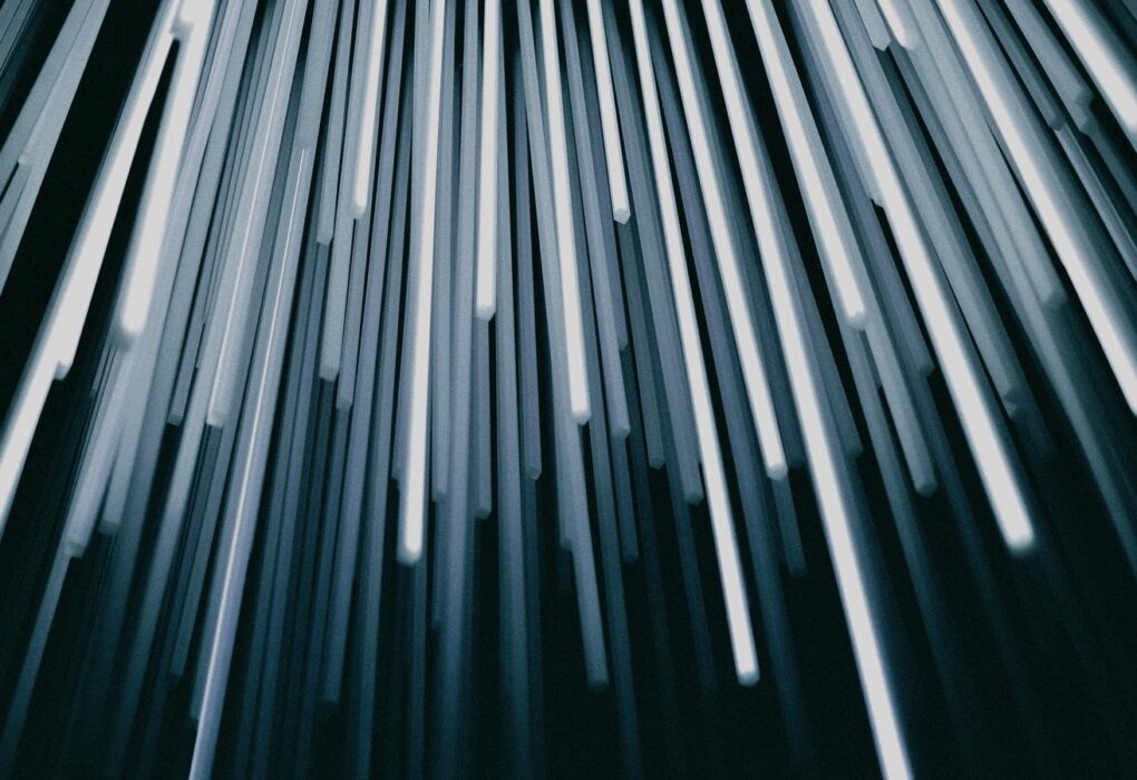 Face-free abstract of glowing fiber-optic strands fanning out from one source
