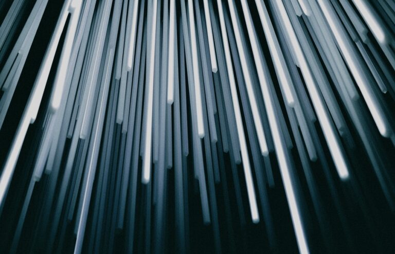 Face-free abstract of glowing fiber-optic strands fanning out from one source