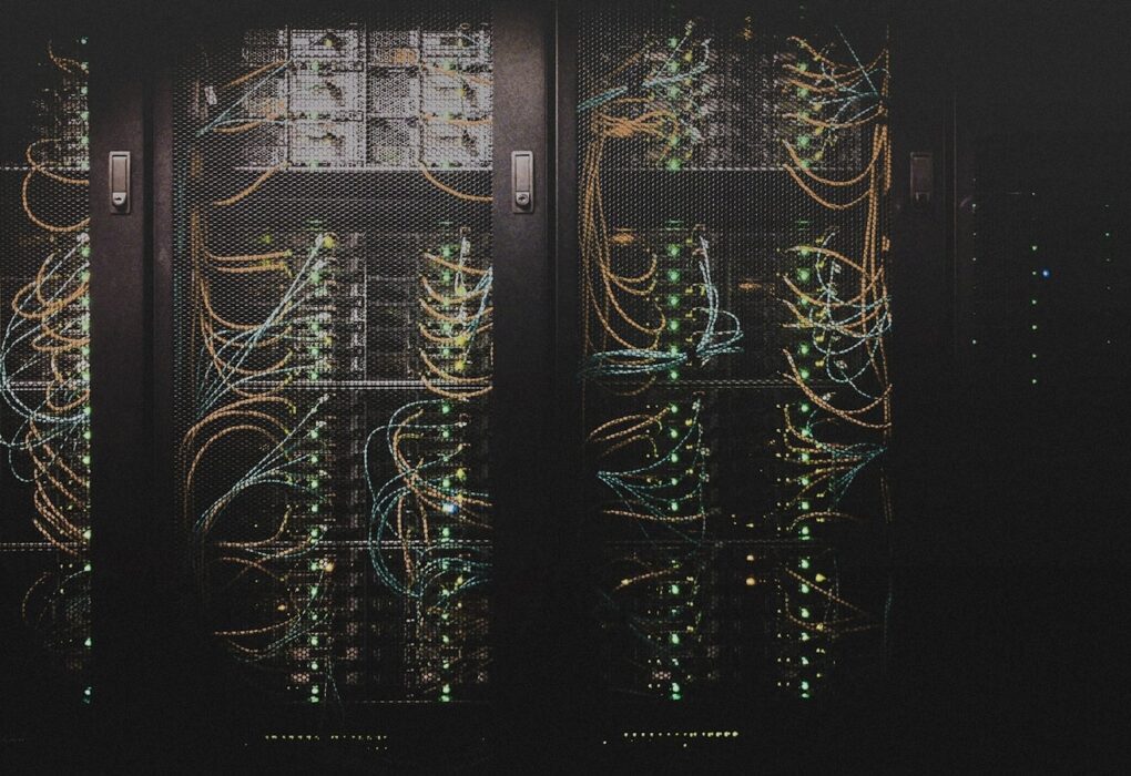 Face-free Unsplash photograph of data-center server racks with network cabling — related still for Cornelis Networks $205M Active Compute Fabric September 2026