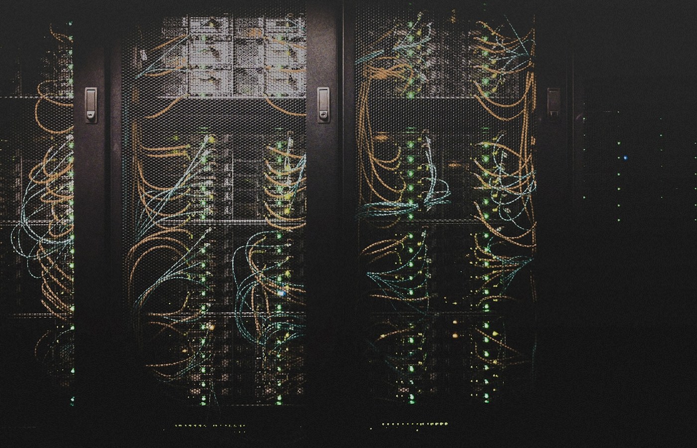 Face-free Unsplash photograph of data-center server racks with network cabling — related still for Cornelis Networks $205M Active Compute Fabric September 2026