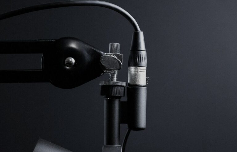 Face-free Unsplash photograph of a studio microphone on a boom arm against a dark background — related still for Google Gemini 3.8 Live speech-to-speech models September 2026