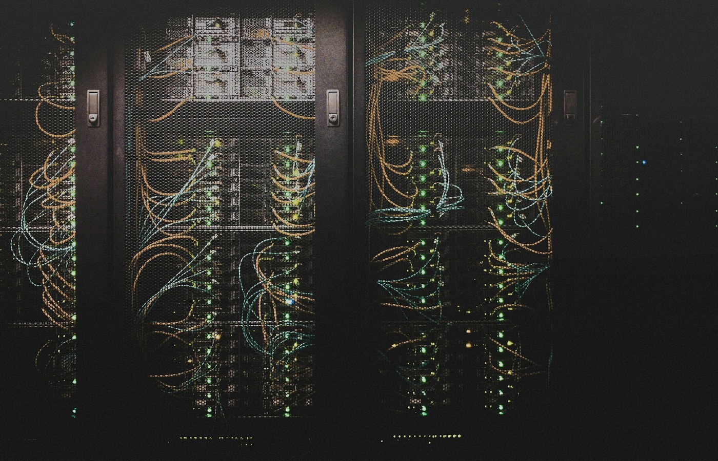 Blue-lit server racks in a dark data center aisle, face-free still for HiddenLayer Series B AI runtime security coverage