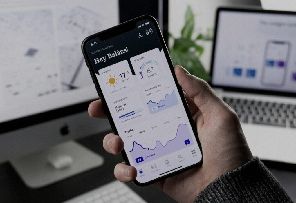 Face-free Unsplash photograph of a hand holding a smartphone showing an abstract mobile dashboard UI — related still for Meta One subscription / paid AI usage news Sep 15 2026