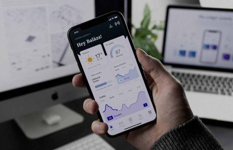 Face-free Unsplash photograph of a hand holding a smartphone showing an abstract mobile dashboard UI — related still for Meta One subscription / paid AI usage news Sep 15 2026