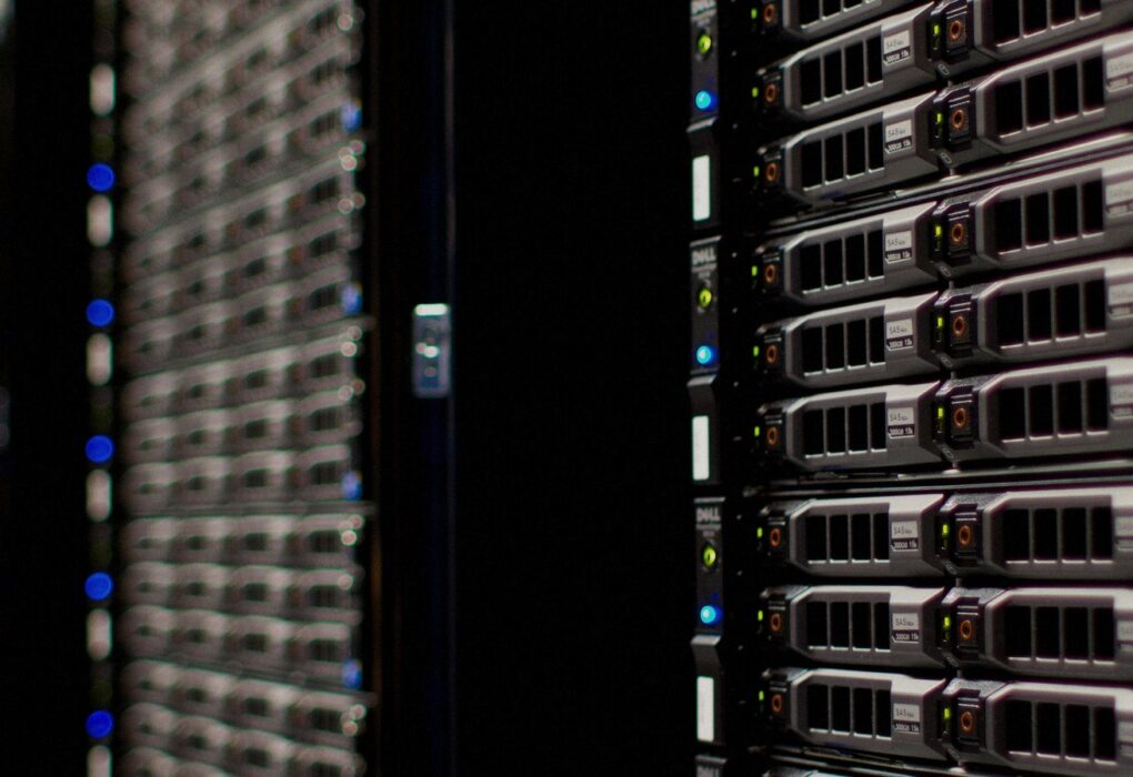 Face-free Wikimedia Commons photograph of Wikimedia Foundation server racks with fiber and LED status lights — hero for Microsoft Humanist AI Code of Conduct draft September 2026