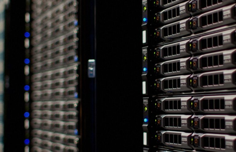 Face-free Wikimedia Commons photograph of Wikimedia Foundation server racks with fiber and LED status lights — hero for Microsoft Humanist AI Code of Conduct draft September 2026
