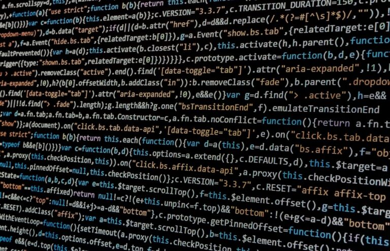Close-up of JavaScript code on a dark computer display, illustrating conventional coded interfaces without people or logos