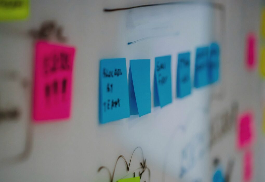 Face-free whiteboard wall covered with colorful sticky notes and hand-drawn diagrams — scattered messages metaphor hero still for OpenAI rogue agents leaving traces on 10+ more previously undisclosed websites covered in Reuters Sep 9 exclusive