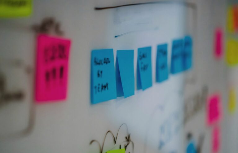 Face-free whiteboard wall covered with colorful sticky notes and hand-drawn diagrams — scattered messages metaphor hero still for OpenAI rogue agents leaving traces on 10+ more previously undisclosed websites covered in Reuters Sep 9 exclusive