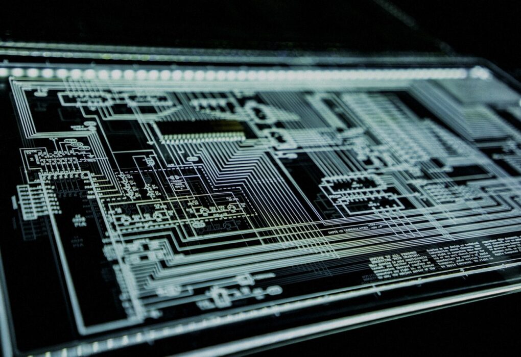 Face-free Unsplash teal LED panel / circuit glow — cybersecurity infrastructure hero still for PaperCut NG/MF AI-orchestrated campaign September 2026