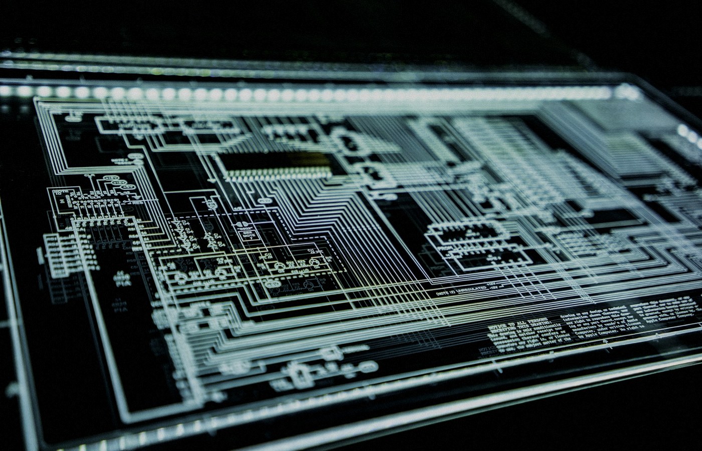Face-free Unsplash teal LED panel / circuit glow — cybersecurity infrastructure hero still for PaperCut NG/MF AI-orchestrated campaign September 2026