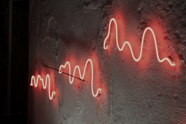 Face-free red neon sound-wave still for Treble acoustic simulation and physical AI, Sep 17 2026