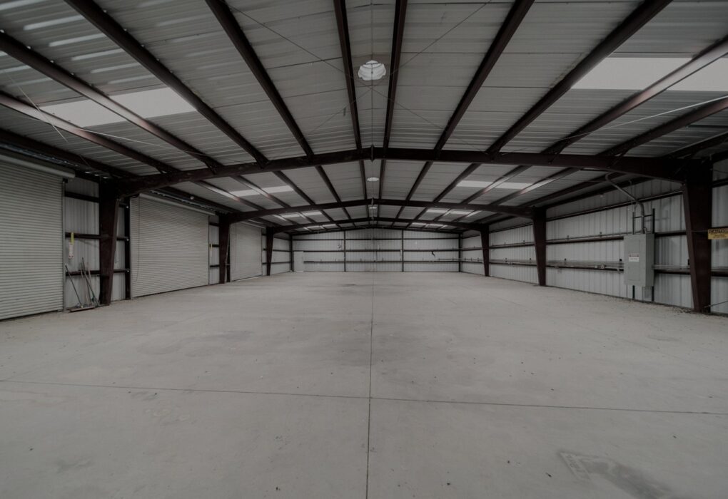 Face-free empty industrial warehouse geometry for Vantora / Silversmith physical-AI corp venture studio, Sep 20 2026