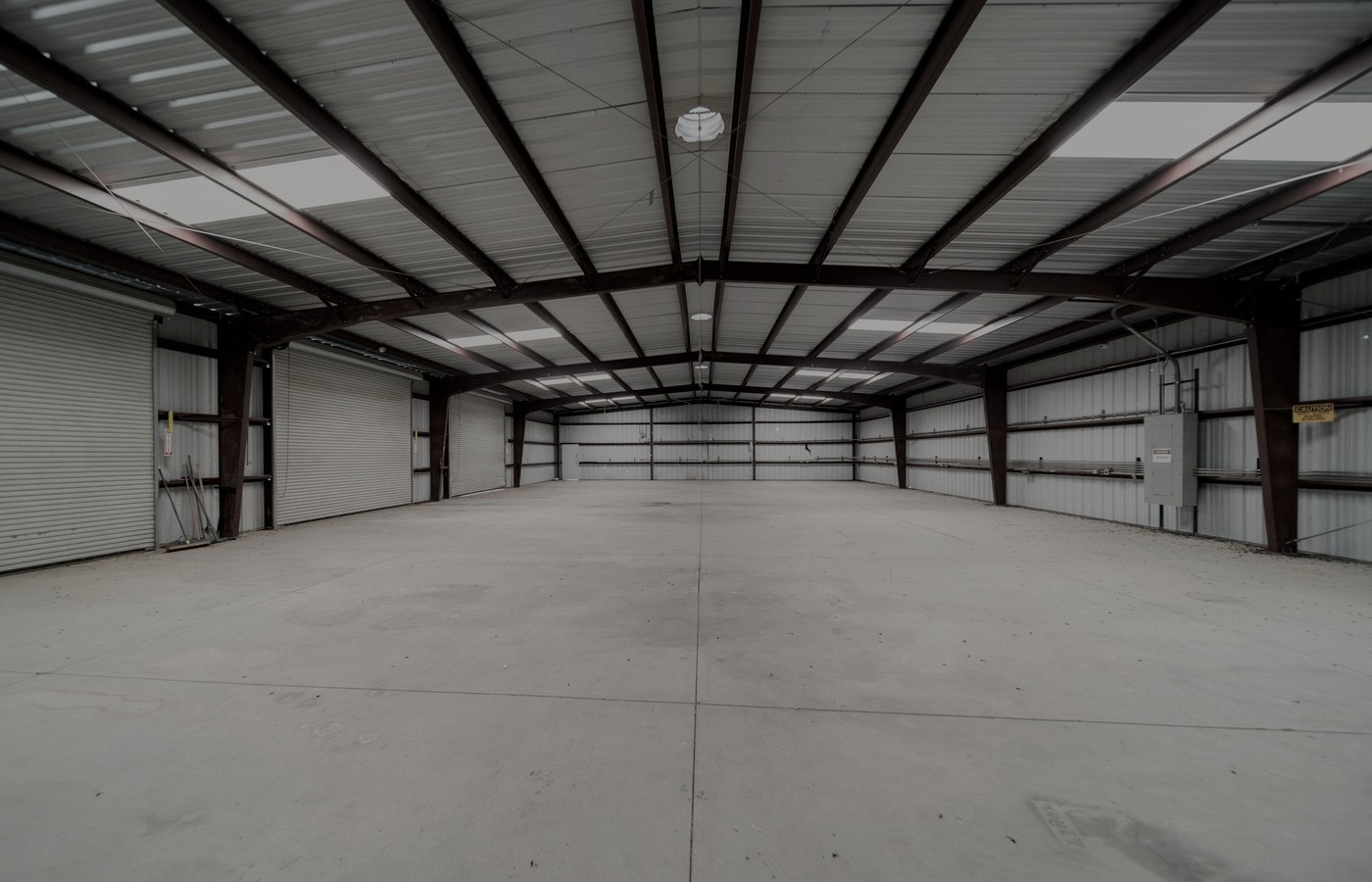 Face-free empty industrial warehouse geometry for Vantora / Silversmith physical-AI corp venture studio, Sep 20 2026