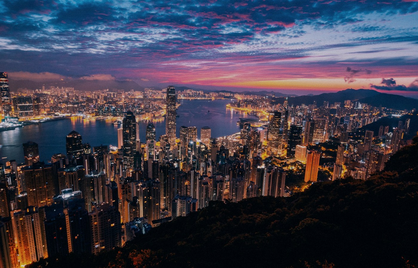 Face-free Unsplash Hong Kong skyline and Victoria Harbour twilight still — hero for Z.AI 2513.HK $5 billion Hong Kong share placement and zero-coupon convertible bond raise September 2026